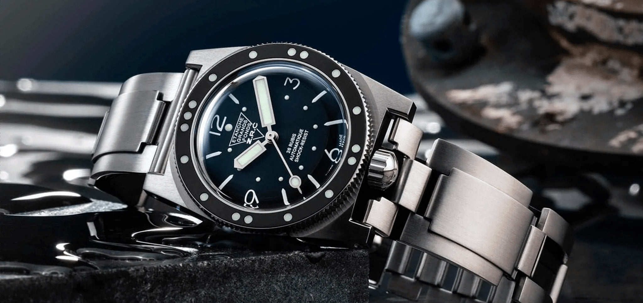 Silver watch with a dark face on a textured surface